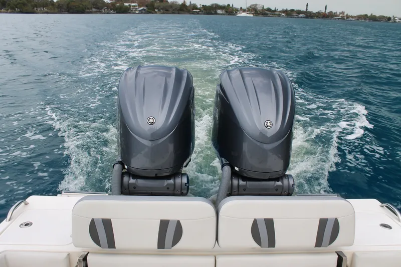 Slide: The Image of 2024 ShearWater 270 SS Open Carolina boat with dual outboard engines on water. - 14