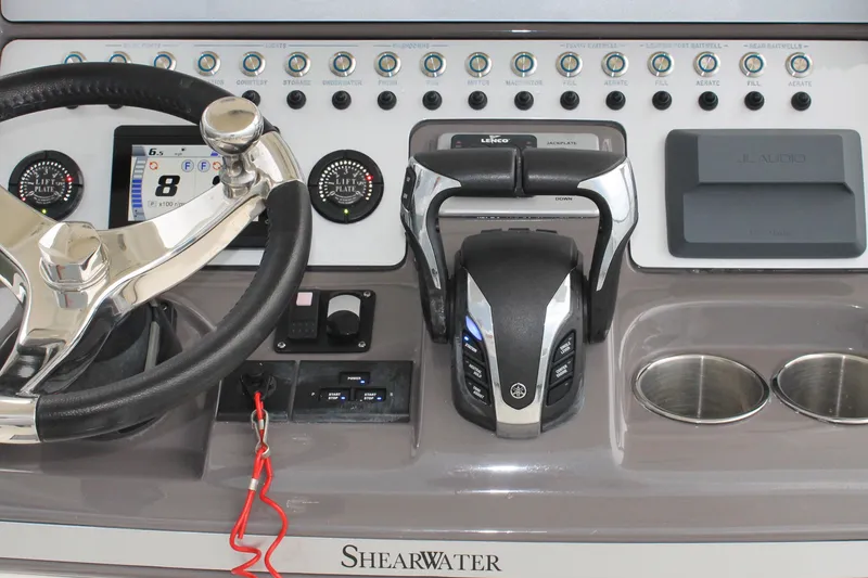 Slide: The Image of 2024 ShearWater 270 SS Open Carolina boat dashboard with steering wheel and controls. - 23