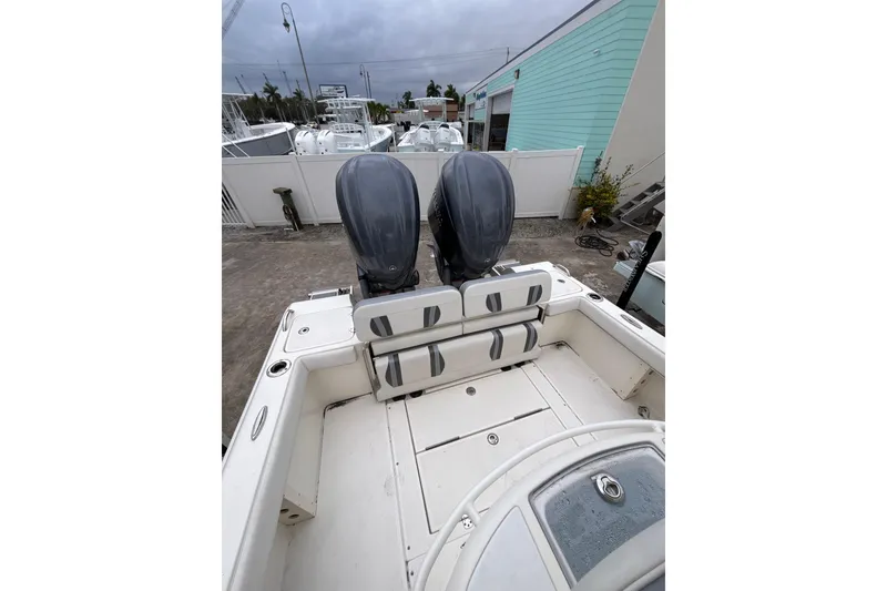 Slide: The Image of 2024 ShearWater 270 SS Open Carolina boat with dual engines, docked outdoors. - 6