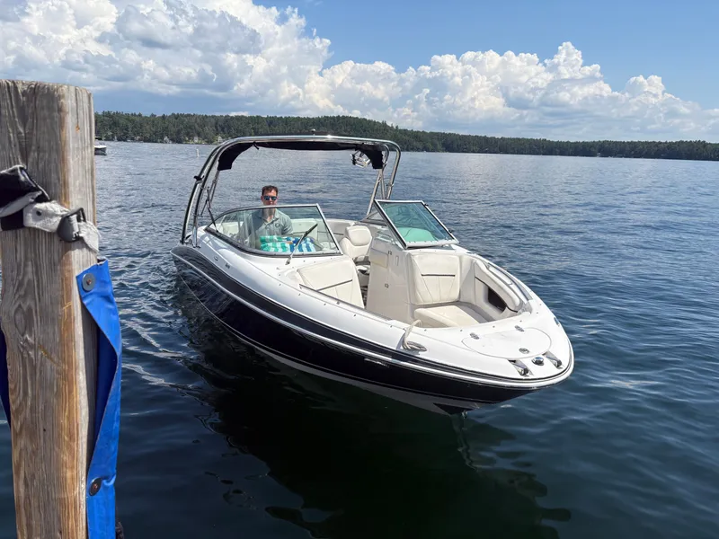 The Image of 2010 Four Winns H240 boat on calm lake under sunny skies. - 1