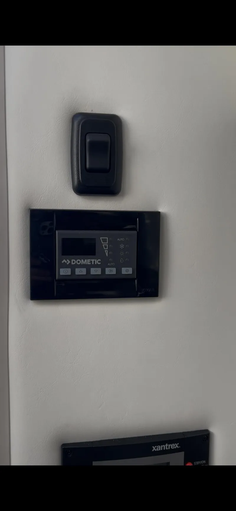 Slide: The Image of Control panel on 2020 Cruisers Yachts 338OB, featuring digital display and switch. - 23