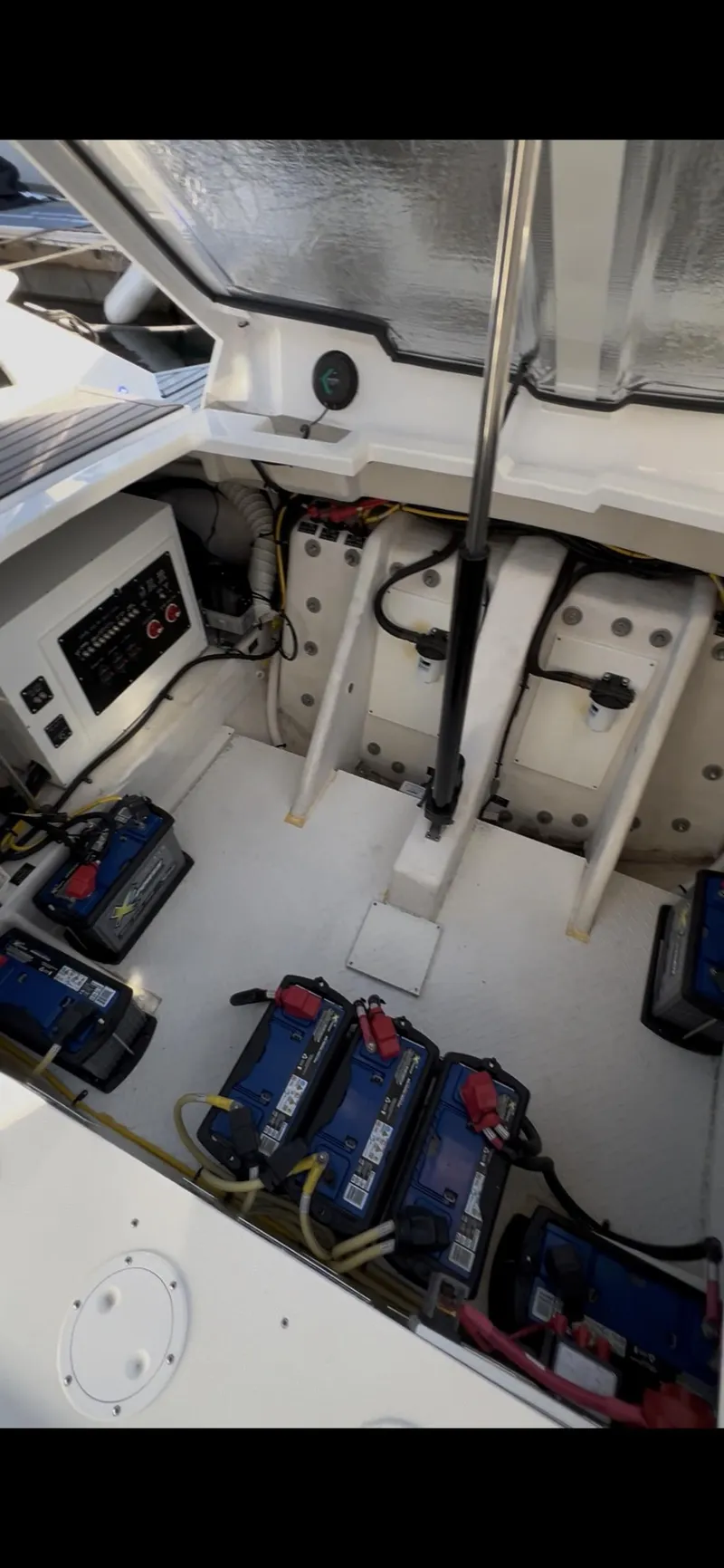 Slide: The Image of 2020 Cruisers Yachts 338OB engine compartment with multiple batteries and wiring. - 28