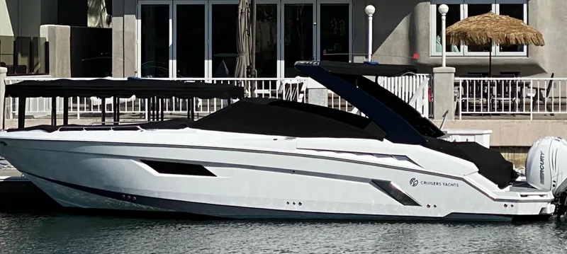 Slide: The Image of 2020 Cruisers Yachts 338OB docked, sleek design, white exterior, modern waterfront setting. - 29