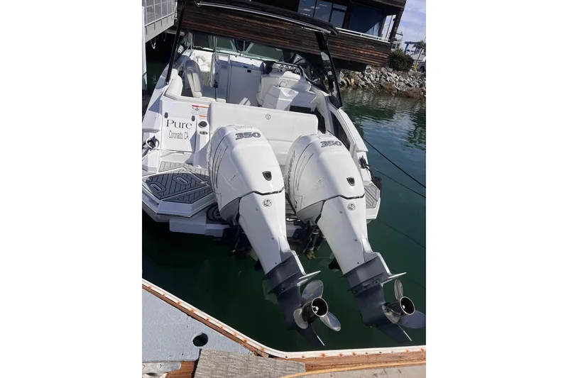 Slide: The Image of 2020 Cruisers Yachts 338 Outboard with twin 350 engines docked in marina. - 4