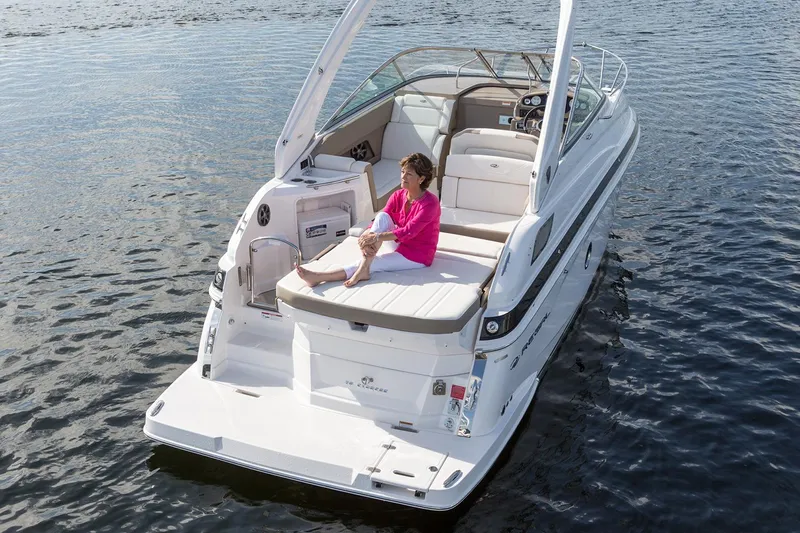 Slide: The Image of Manufacturer Provided Image: 2017 Regal 28 Express boat on water with person relaxing on deck. - 2