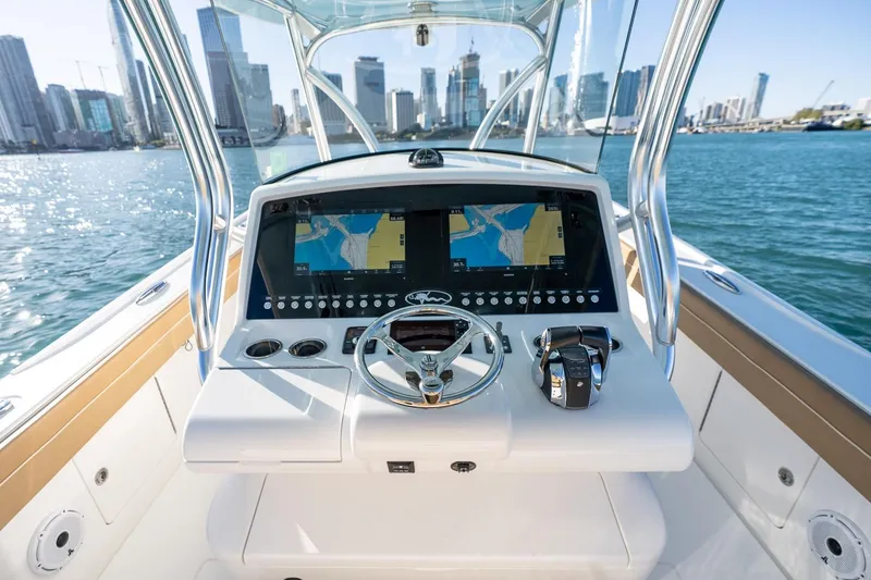 Slide: The Image of 2022 Valhalla Boatworks V-37 helm with dual navigation screens, city skyline in background. - 16