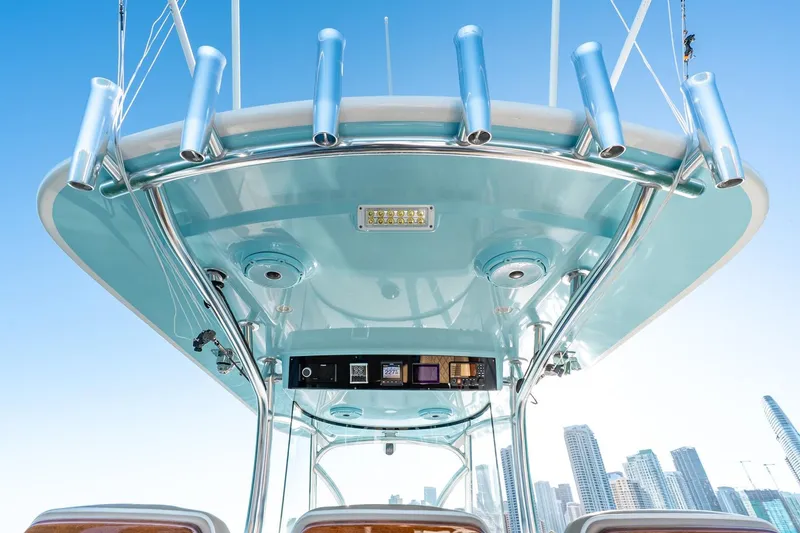 Slide: The Image of 2022 Valhalla Boatworks V-37 helm with rod holders against city skyline. - 19