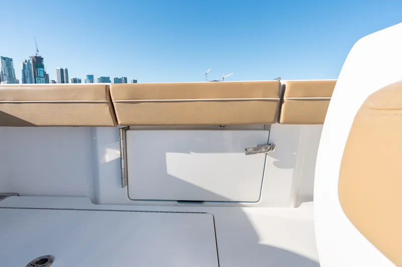 Slide: The Image of 2022 Valhalla Boatworks V-37 interior with tan seating and city skyline background. - 32