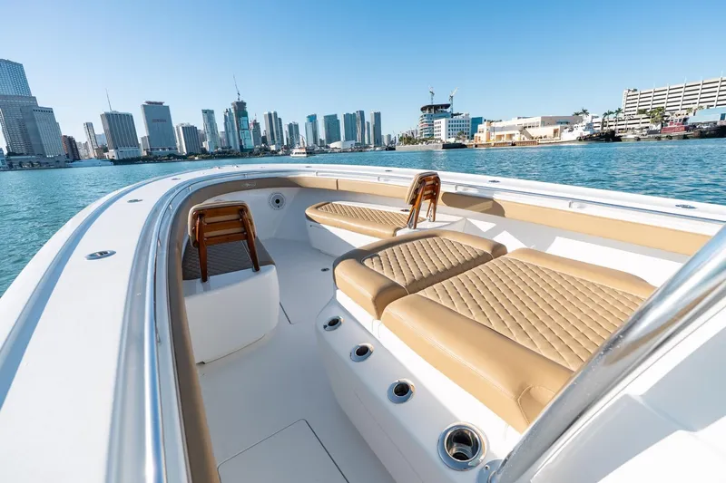 Slide: The Image of 2022 Valhalla Boatworks V-37 with luxurious seating, city skyline in background. - 33