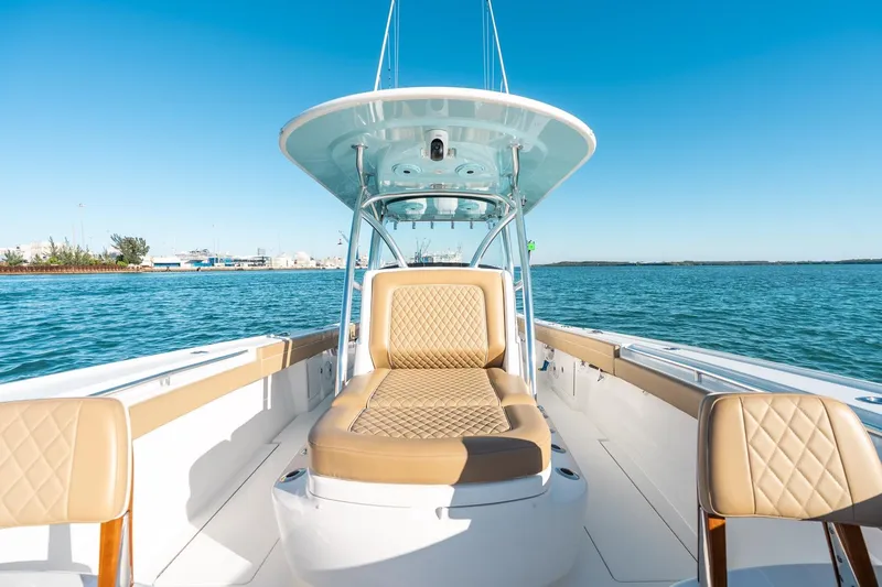 Slide: The Image of 2022 Valhalla Boatworks V-37 on water, featuring luxurious tan seating and sleek design. - 37