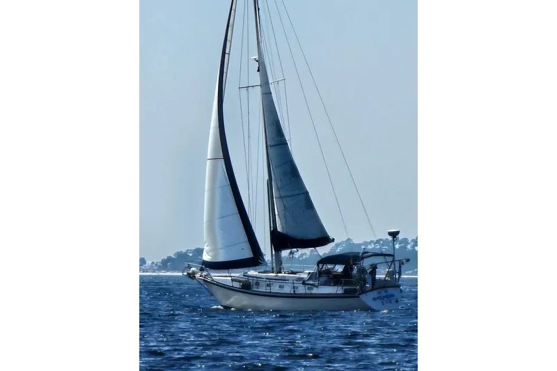 The Image of Sailboat on open water, Caliber 38, 1988 model, cruising under clear skies. - 0