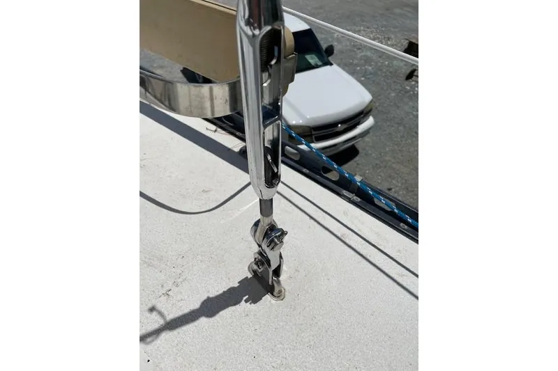 Slide: The Image of Close-up of a 1988 Caliber 38 sailboat rigging detail with a car in the background. - 11