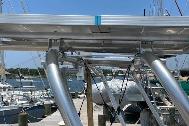 Slide: The Image of Sailboat docked with solar panels, Caliber 38, 1988 model, marina background. - 20