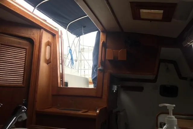 Slide: The Image of Interior of 1988 Caliber 38 sailboat with wooden cabinetry and open hatch. - 3