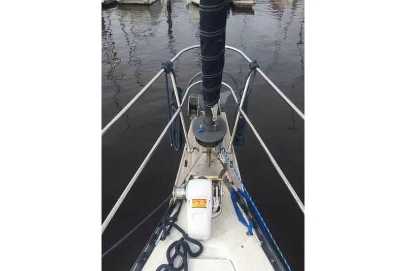 Slide: The Image of Bow of 1988 Caliber 38 sailboat with ropes and winch in marina. - 6