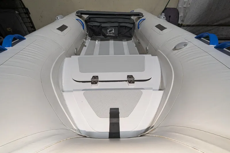Slide: The Image of 2025 Zodiac Nomad 3.3 RIB Alu inflatable boat interior with storage compartment. - 2