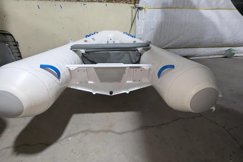 Slide: The Image of 2025 Zodiac Nomad 3.3 RIB Alu inflatable boat in a garage setting. - 7