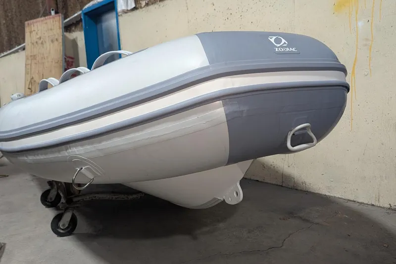 Slide: The Image of 2025 Zodiac Cadet RIB Alu 330 inflatable boat in storage, showcasing its sleek design. - 7