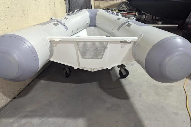 Slide: The Image of 2025 Zodiac Cadet RIB Alu 330 inflatable boat in storage, showcasing durable design. - 8