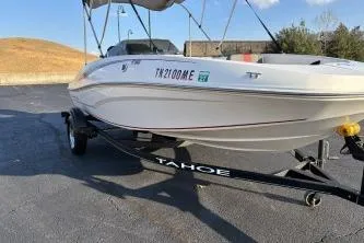 The Image of 2023 Tahoe T16 boat on trailer, parked outdoors under clear sky. - 1