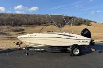 Slide: The Image of 2023 Tahoe T16 boat on trailer, parked outdoors with scenic background. - 3