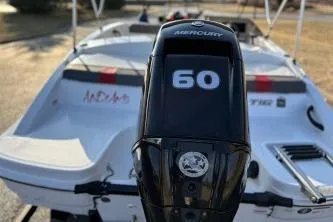 Slide: The Image of 2023 Tahoe T16 boat with Mercury 60 engine, rear view. - 6