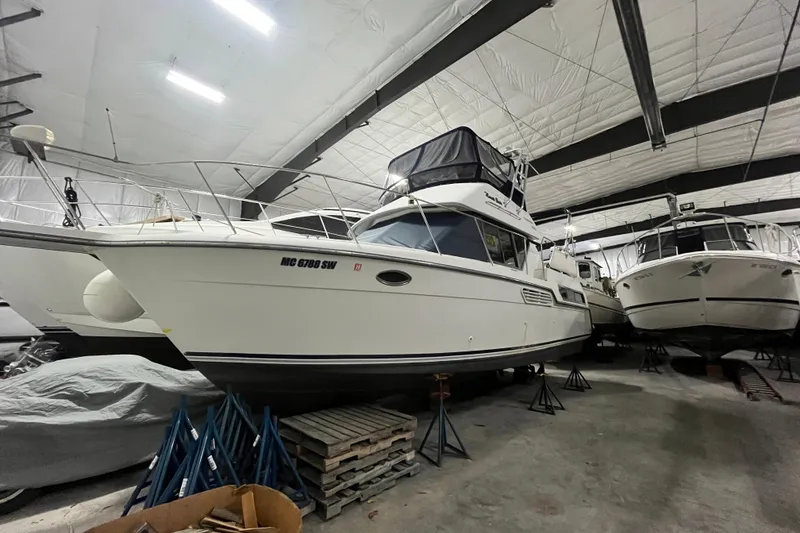 The Image of 1995 Carver 325 Aft Cabin Motor Yacht in indoor storage facility. - 1