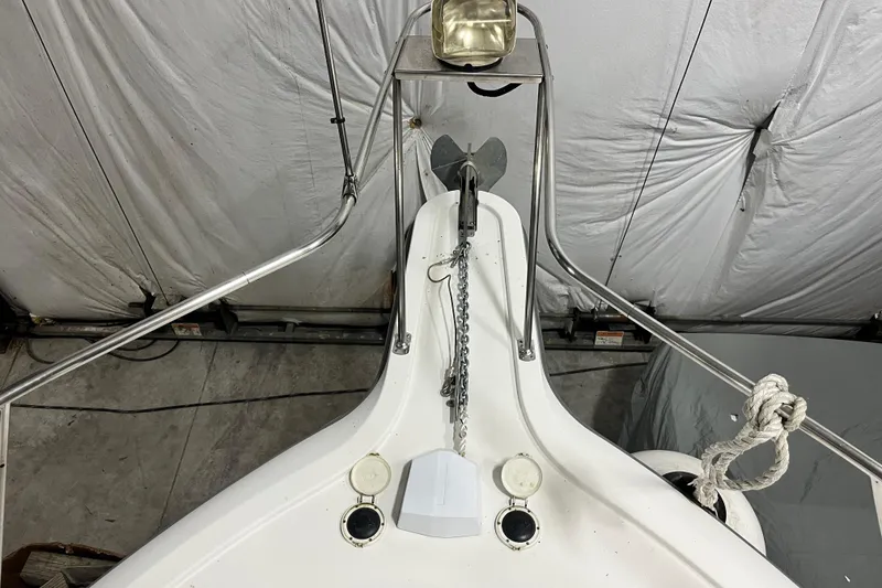 Slide: The Image of 1995 Carver 325 Aft Cabin Motor Yacht bow with anchor and railing in storage. - 12