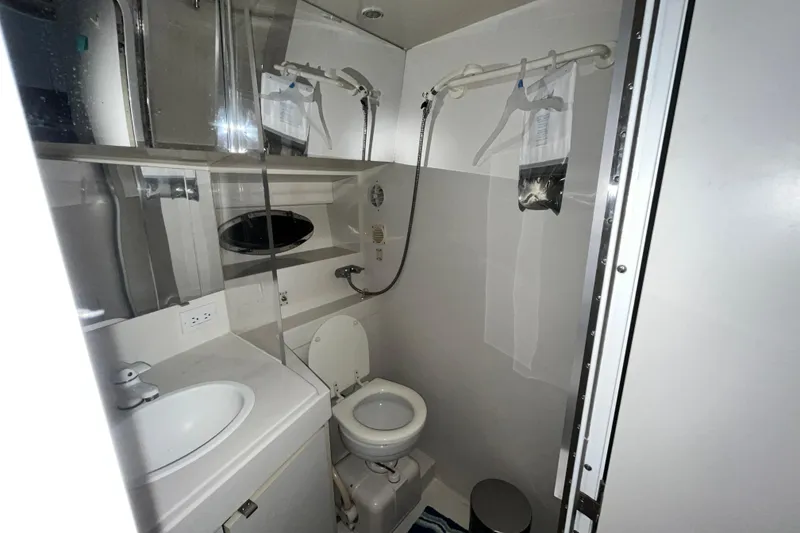 Slide: The Image of Bathroom interior of 1995 Carver 325 Aft Cabin Motor Yacht, featuring sink and toilet. - 15