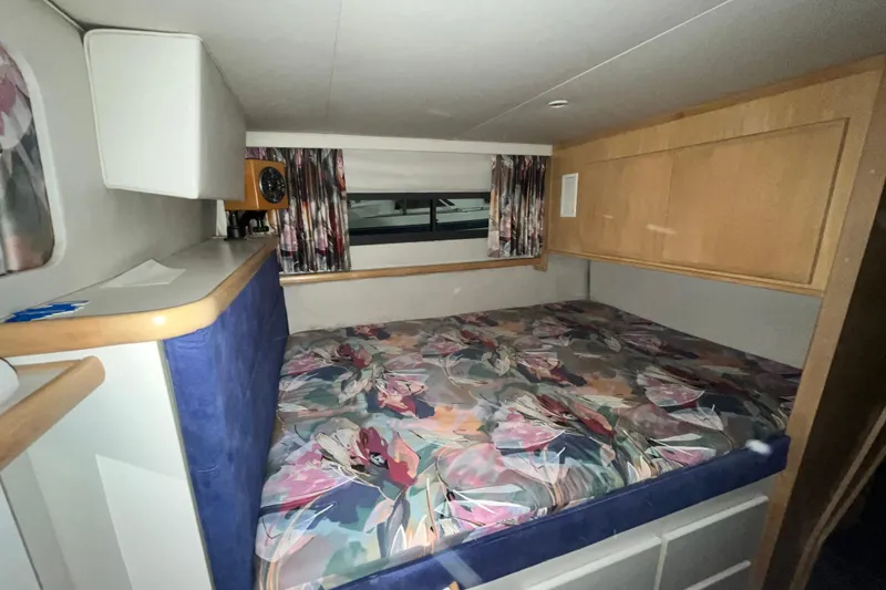 Slide: The Image of Cozy bedroom in 1995 Carver 325 Aft Cabin Motor Yacht with floral bedding. - 21