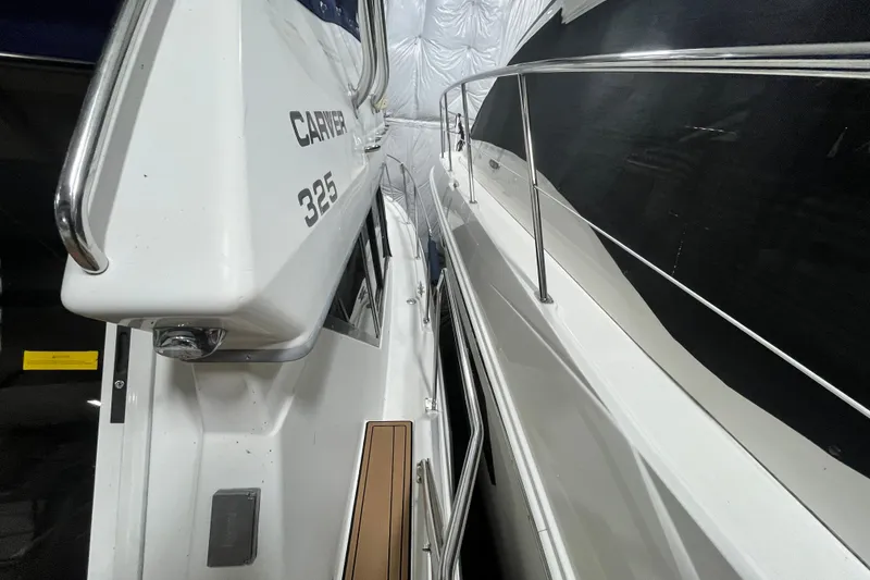 Slide: The Image of 1995 Carver 325 Aft Cabin Motor Yacht, side view in storage facility. - 5