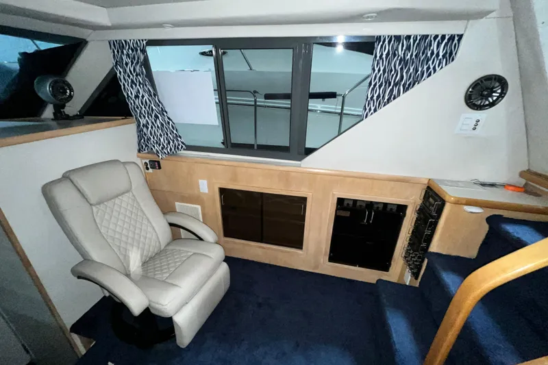 Slide: The Image of Interior of 1995 Carver 325 Aft Cabin Motor Yacht with chair and window view. - 13