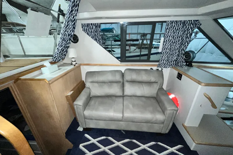 Slide: The Image of Interior of 1995 Carver 325 Aft Cabin Motor Yacht with sofa and nautical decor. - 14