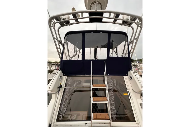 Slide: The Image of 1995 Carver 325 Aft Cabin Motor Yacht with covered upper deck and ladder. - 3