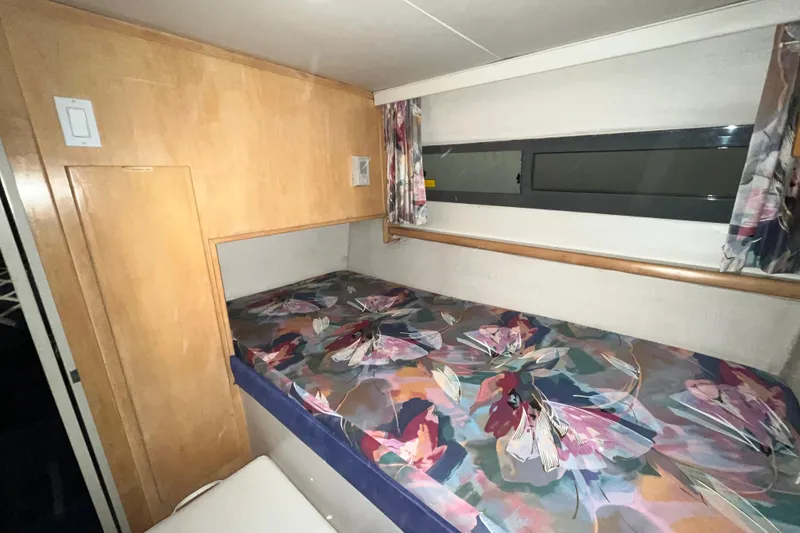 Slide: The Image of Cozy cabin interior of 1995 Carver 325 Aft Cabin Motor Yacht with floral bedding. - 20