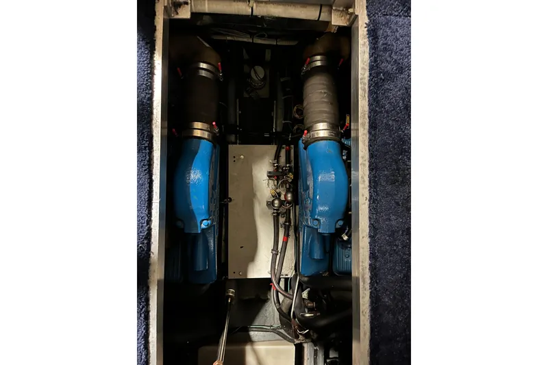 Slide: The Image of Engine compartment of 1995 Carver 325 Aft Cabin Motor Yacht, featuring dual blue engines. - 22