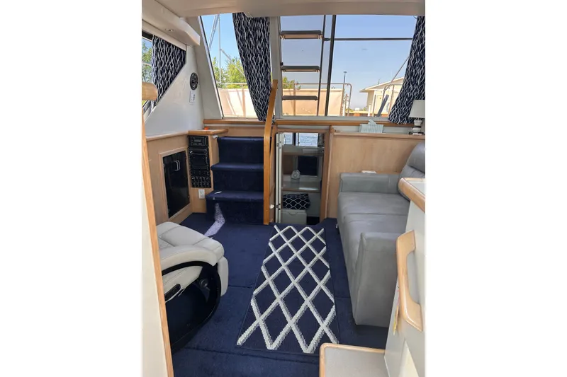 Slide: The Image of Interior of 1995 Carver 325 Aft Cabin Motor Yacht with modern furnishings and nautical decor. - 4