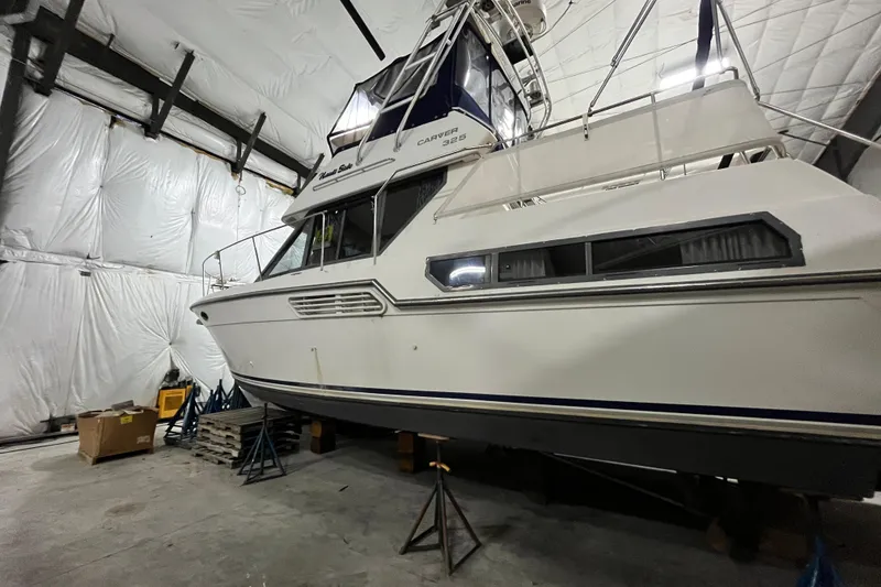 Slide: The Image of 1995 Carver 325 Aft Cabin Motor Yacht in storage, side view. - 25