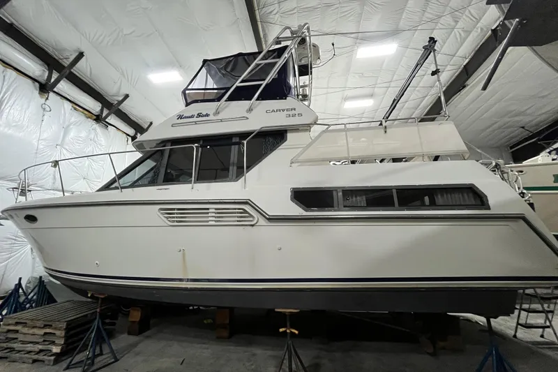 Slide: The Image of 1995 Carver 325 Aft Cabin Motor Yacht in indoor storage facility. - 26