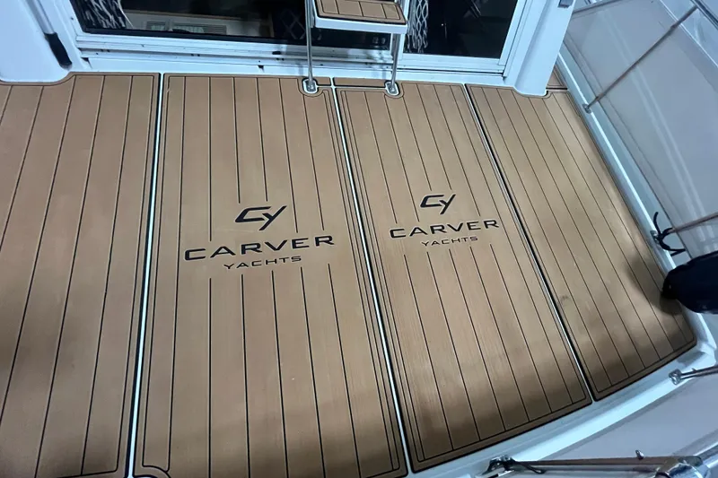 Slide: The Image of Carver 325 Aft Cabin Motor Yacht 1995 deck with logo, teak flooring. - 3