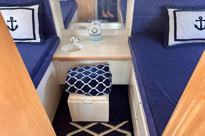 Slide: The Image of Interior of 1995 Carver 325 Aft Cabin Motor Yacht with nautical-themed bedding. - 8