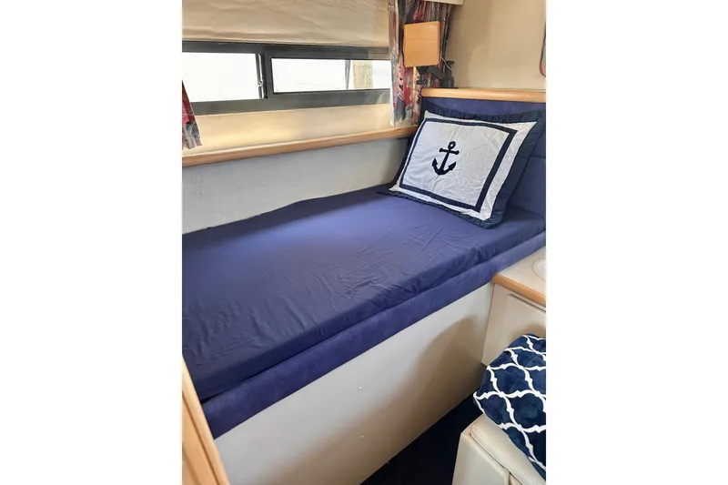 Slide: The Image of Cozy cabin bed in 1995 Carver 325 Aft Cabin Motor Yacht with nautical-themed pillow. - 9