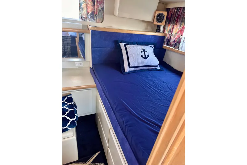 Slide: The Image of Cozy cabin interior of 1995 Carver 325 Aft Cabin Motor Yacht with nautical-themed bedding. - 10