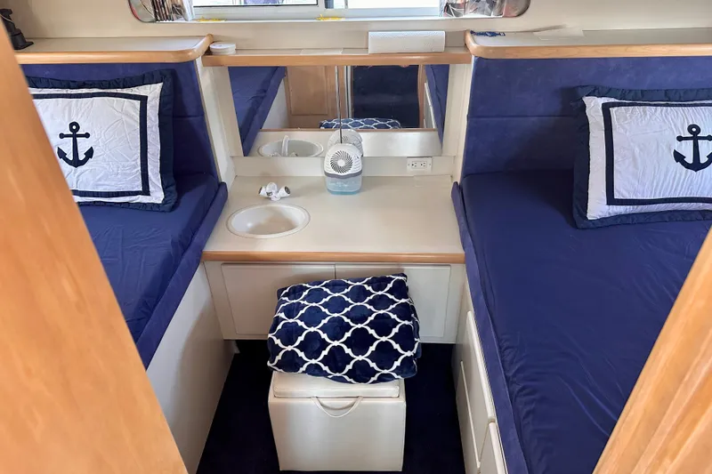 Slide: The Image of Interior of 1995 Carver 325 Aft Cabin Motor Yacht with nautical-themed bedding. - 11