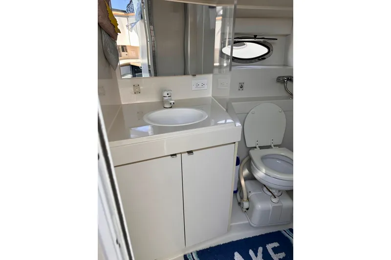 Slide: The Image of Bathroom interior of 1995 Carver 325 Aft Cabin Motor Yacht, featuring sink and toilet. - 7