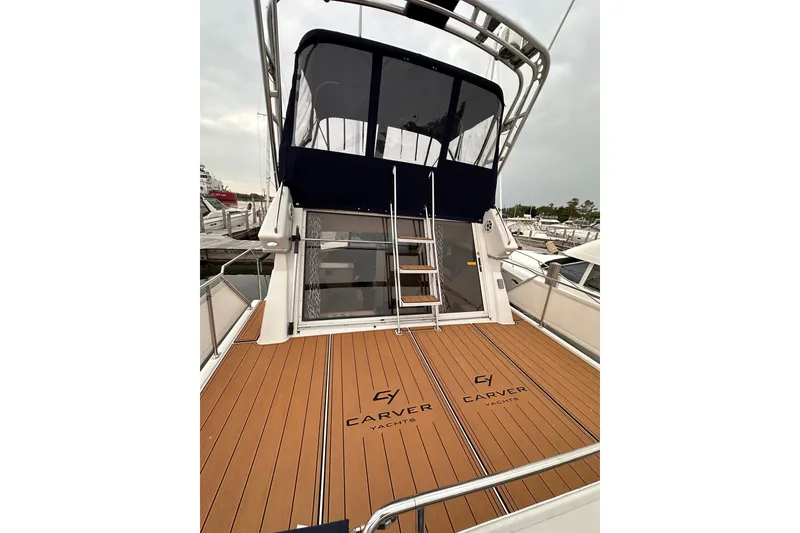 Slide: The Image of 1995 Carver 325 Aft Cabin Motor Yacht with teak deck and ladder to upper cabin. - 2