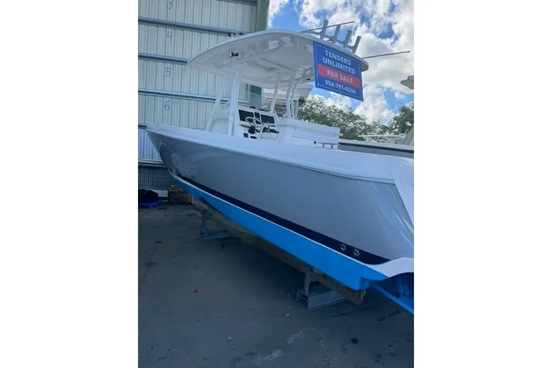 The Image of 2014 Intrepid 327 Center Console boat for sale, docked outdoors. - 0