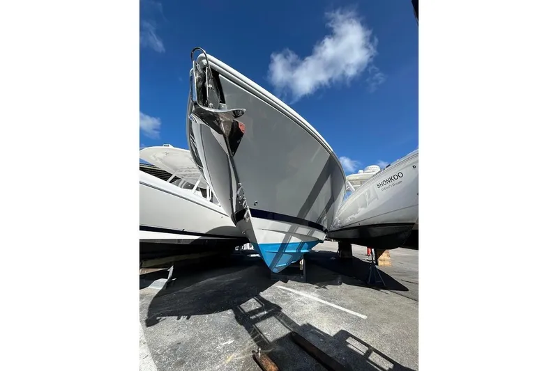 Slide: The Image of 2014 Intrepid 327 Center Console boat on display under a clear blue sky. - 15
