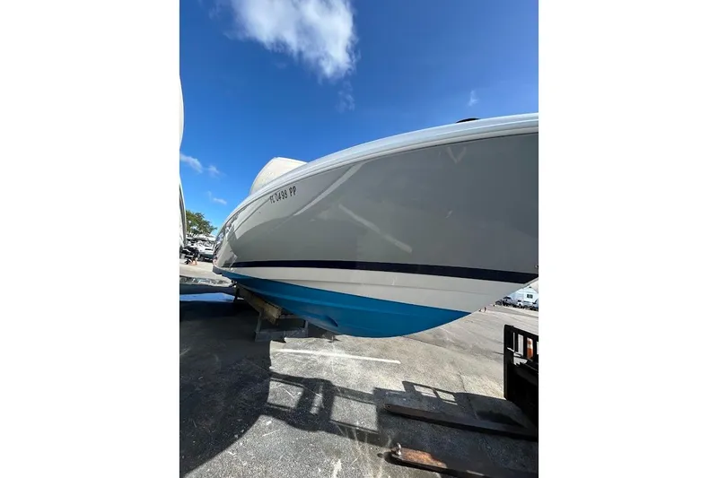 Slide: The Image of 2014 Intrepid 327 Center Console boat on trailer under clear blue sky. - 17