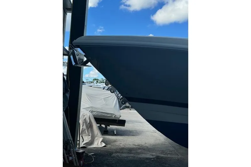 Slide: The Image of 2014 Intrepid 327 Center Console boat in storage, blue sky background. - 3